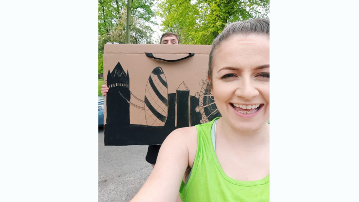 Smiling running woman with picture of london skyline behind her