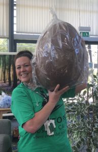 Happy Treetops staff member with giant Easter Egg