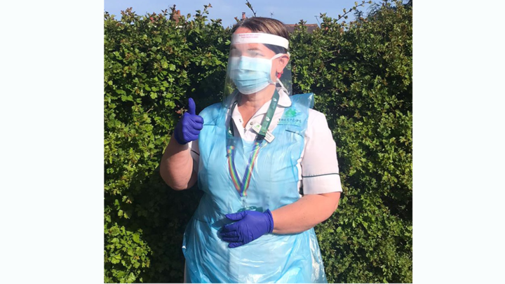 Nurse in PPE giving a thumbs up