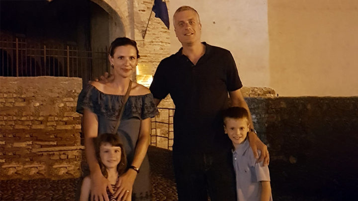 Family photo of parents and two children on holiday