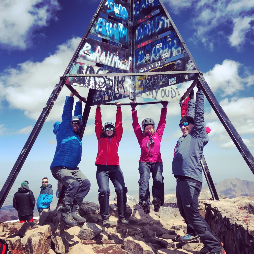 People celebrating reaching the top of Mt Toubkal