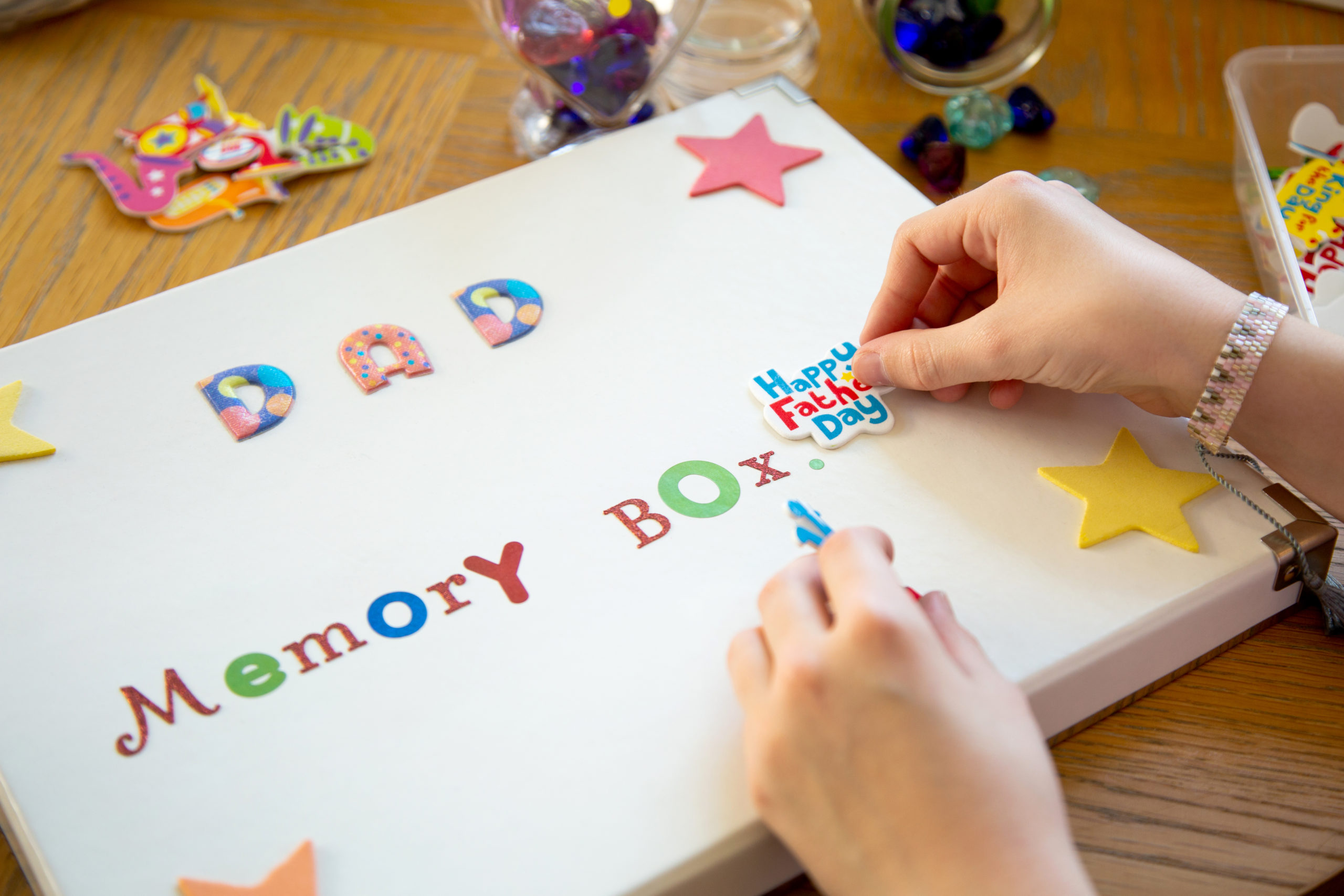 Child's hand making a memory box