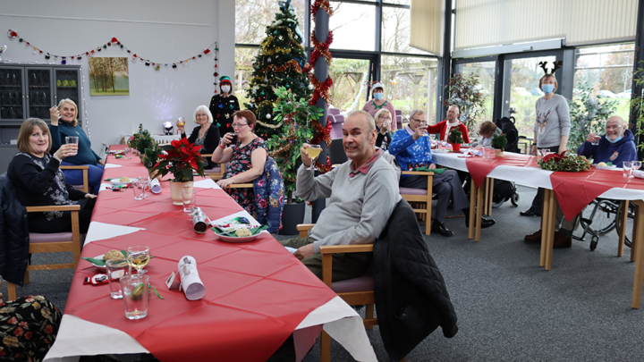 Group of patients enjoying Christmas dinner