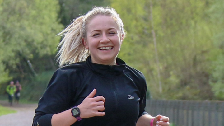 Young woman smiling as she runs for Treetops