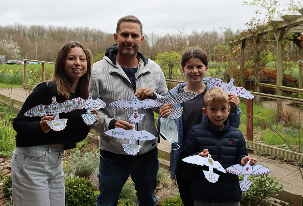 Family holding decorated Peace Doves