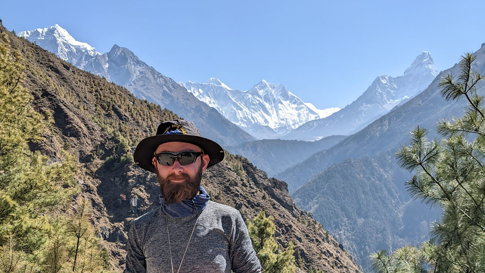Man with mountains in background