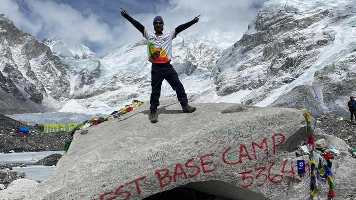 man cheering at Mount Everest base camp
