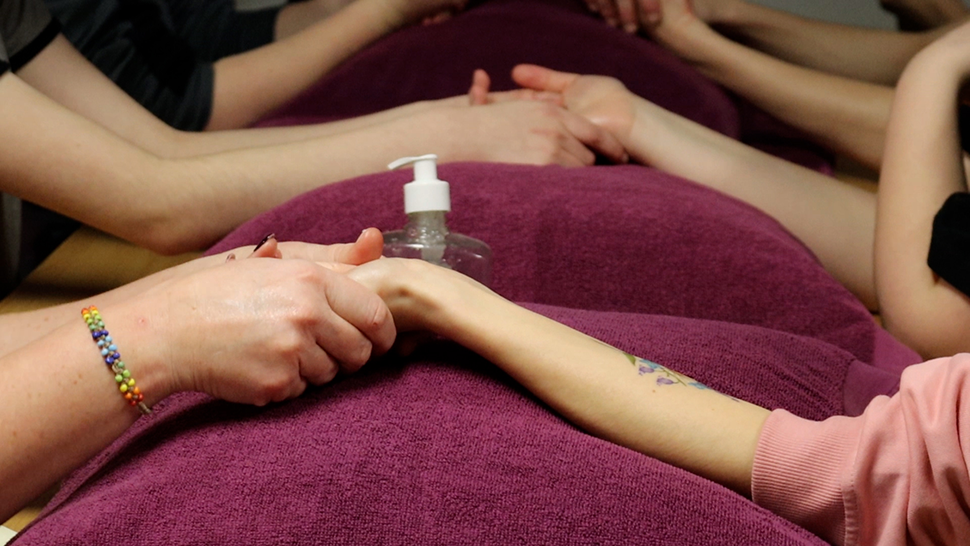 Young people giving each other a hand massage