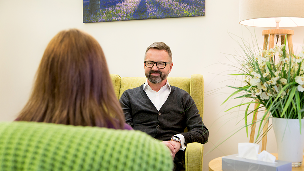 Man smiling in a counselling room