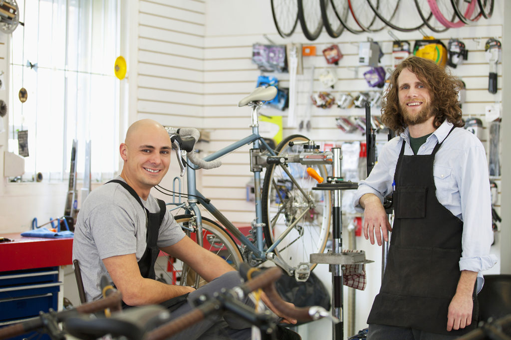 men in bike repair shop