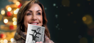 Smiling woman holding photo for Light Up a Life appeal