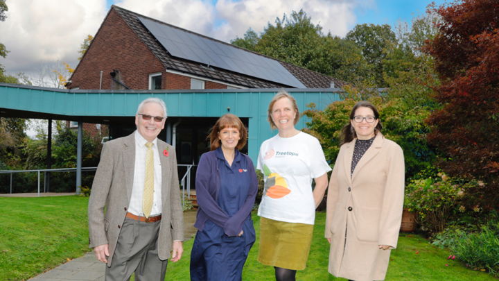 Group of people visiting Treetops to see solar panel installation