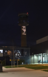 East Midlands Airport control tower lit up with Light Up a Life logo