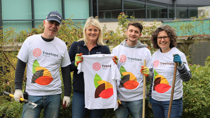 Smiling volunteers from TSB in Treetops t-shirts
