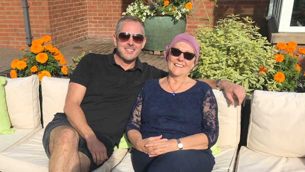 Son and mother sitting outside in the sunshine smiling