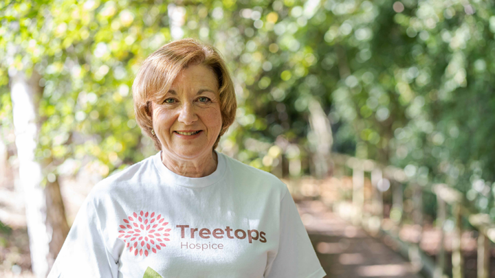 Woman smiling in Treetops t-shirt standing