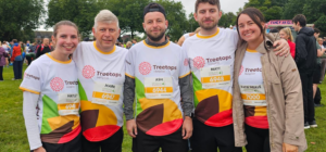 Group of five people wearing Treetops t-shirts at half-marathon