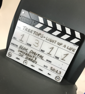 Black and white clapper board for a film with writing on