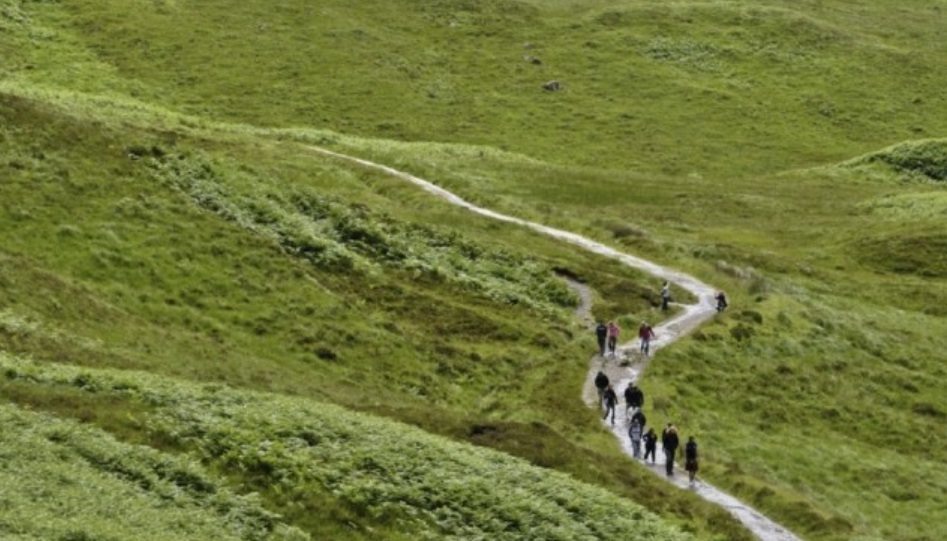 the winding paths of the Yorkshire three peaks, with people walking uphill