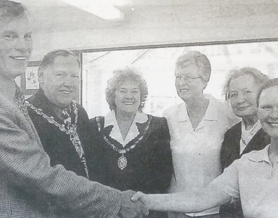Five individuals greeting each other in a black and white