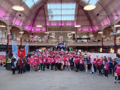 A large group of people wearing pink t-shirts