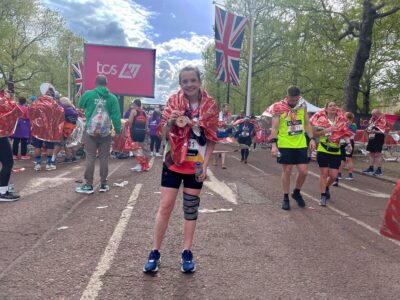 woman in running outfit with medal