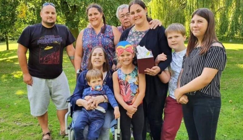 A family stood together in a park.